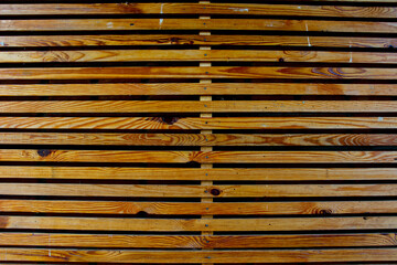 Background from a lattice from yellow wooden boards.