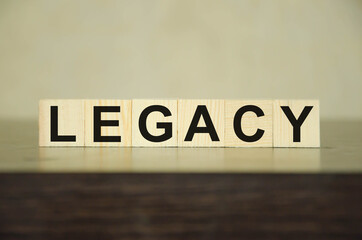 legacy - written on dice, money or property left to someone according to the concept of heritage, white background.