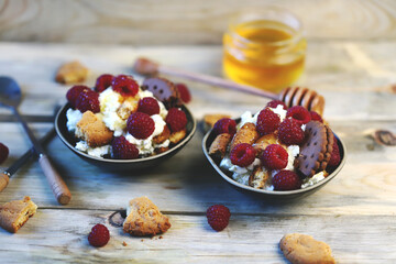 Selective focus. A healthy dessert with mascarpone cheese, biscuits and raspberries.