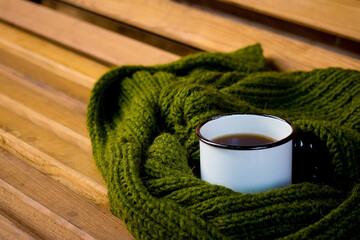 a cup of tea on a bench in the park