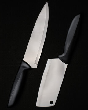 Chef's knife and meat cleaver isolated on black background