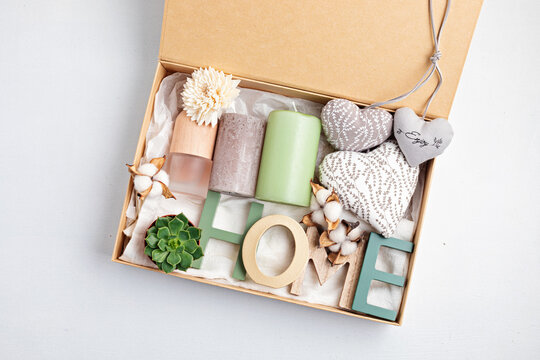 Preparing care package, seasonal gift box with candles, succulent, interior scent. Personalized eco friendly basket