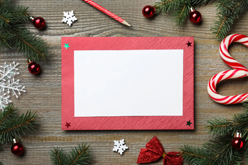 Fototapeta na wymiar Flat lay composition with Christmas decor and blank card on wooden background. Space for text