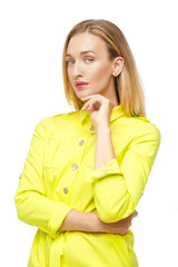 Studio portrait of a young adult woman with straight fair hair and nude make-up posing in buttoned up lemon yellow blouse or dress.
