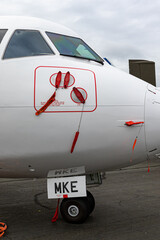 Fototapeta na wymiar commuter aircraft with remove before flightbtags 