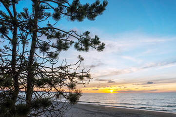 Sunset over the sea. Reflection of sunlight in the sea waves. The sky in the sunset rays. Russia Baltic Sea.