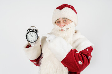 Santa Claus shows the time remaining before Christmas on the clock. Isolated on white