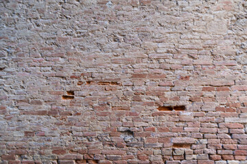 Fototapeta na wymiar Red brick wall. Scratched old wall. Red bricks