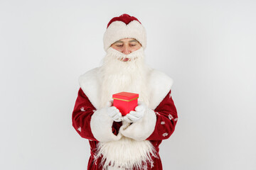 Fototapeta na wymiar Santa Claus holds gifts in his hands. Isolated on white