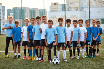 young football players boys ready to play, they divided into groups, going to participate in the...