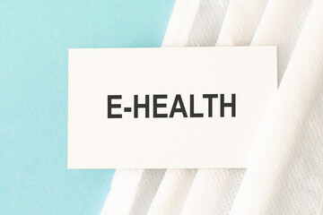 Word e-health with medical mask on a blue background. Medicine concept