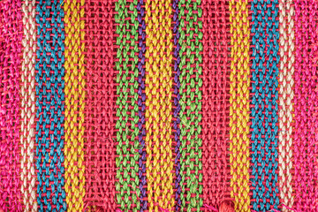 Colorful striped woven jute bag background
Close-up of the burlap fabric from a Mexican market bag
