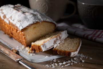 Fresh sliced ​​muffin with powdered sugar on wooden table
