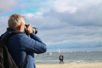 Photographer takes pictures of the beach in Poland. City Gdynia.