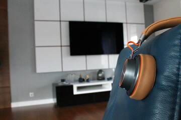 Wireless headphones on a sofa couch in the livingroom of a home for relaxing and listening to music