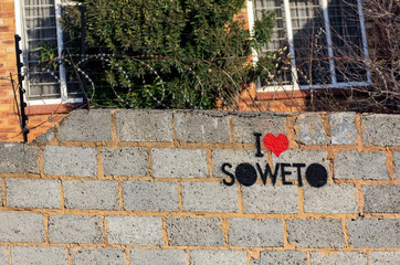 I LAVE SOWETO - an inscription on a fence with barbed wire. Black lives matter.