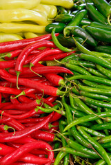 Red yellow and green jalapeno peppers at the market