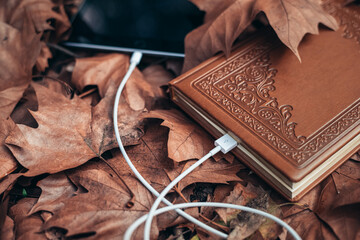 concept of autumn inspiration. Autumn time. tablet and notebook lying between autumn leaves