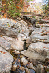 Stream and waterfall flowing through sculptured rocks in the woods