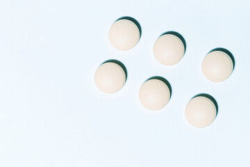 image of round tablets on a white background .