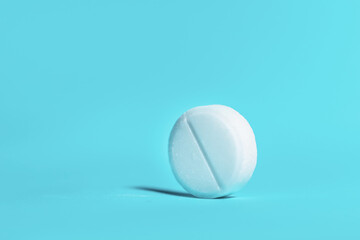 large white tablet on a blue background .