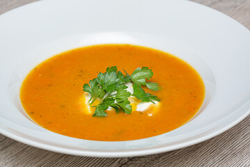 carrot soup in a white bowl