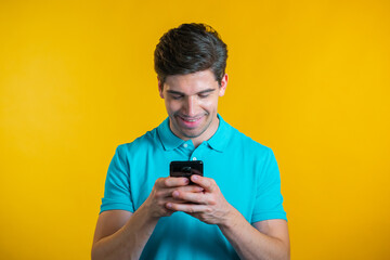 Handsome man receives happy notification on mobile phone. Guy is beside himself with surprise and joy. He won and rejoices. Technology, success, victory, happiness concept.