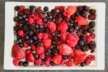 Frozen mixed berries on a white dish.