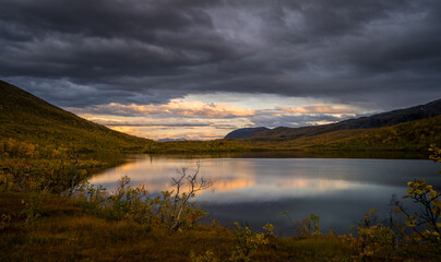 Fototapeta na wymiar Beautiful sunset over a Lake in a Mountain landscape
