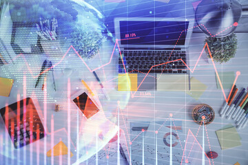 Multi exposure of forex chart drawing over table background with computer. Concept of financial research and analysis. Top view.