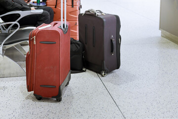 Travelers with suitcases through the airport in departure lounge