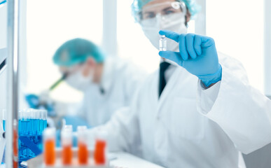 background image of a scientist recording test results in a lab log.