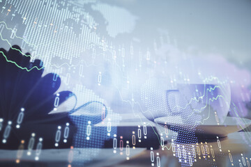 Double exposure of financial chart drawing and desktop with coffee and items on table background. Concept of forex market trading