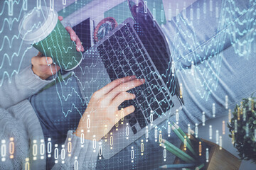 Double exposure of woman hands typing on computer and forex chart hologram drawing. Stock market invest concept.