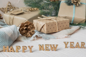 Happy new year lettering in gold letters on the background of gift boxes. Happy New year and merry Christmas.