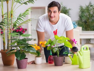 Young man in gardening concept at home
