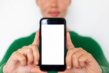 People showing a blank smartphone screen to the camera. Online electronic advertisement.