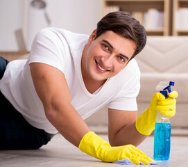 Man husband cleaning the house helping wife
