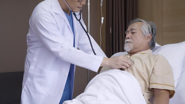 Doctor talking Consultant elderly male patient in hospital. Explain an X-ray about cancer treatment, lung disease and physical health. Retirement or Treatment health insurance. Concept Health care