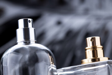 close up macro perfume spray bottles over dark luxury background. gloomy perfume containers. copy...