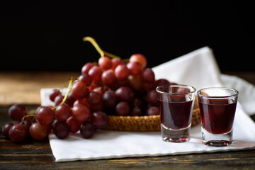 Red grape juice in glass with grape fruit