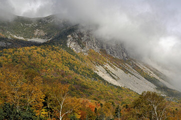 Threatening dark low clouds enveloping rocky summit of Cannon Mountain in New Hampshire's Franconia Notch Sate Park.