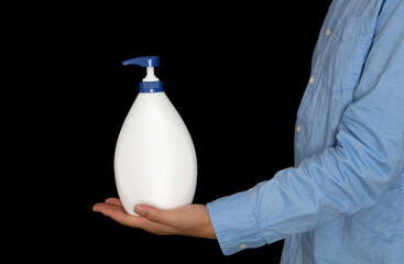 Man holding hand sanitizer in front of black background