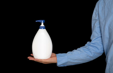 Man holding hand sanitizer in front of black background