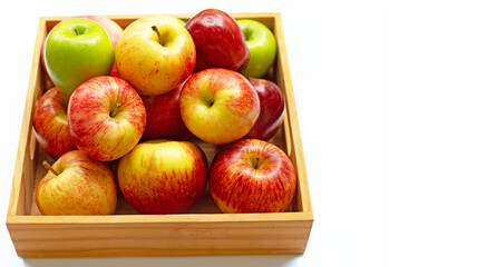Fresh apples in wooden box on white