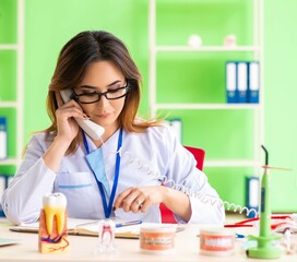 Woman dentist working on teeth implant