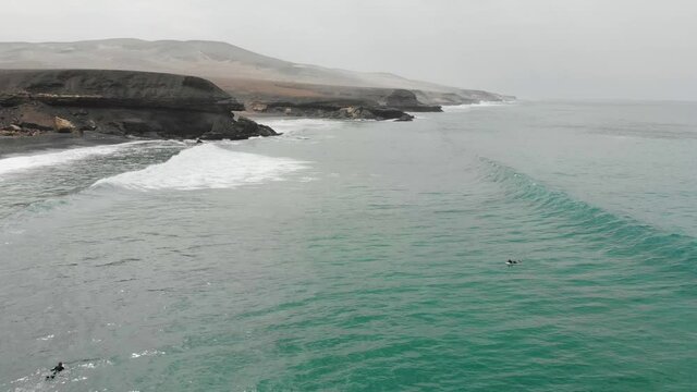 Surfer riding on powerful ocean wave.Surfing ocean lifestyle. Aerial tracking cinematic shot.