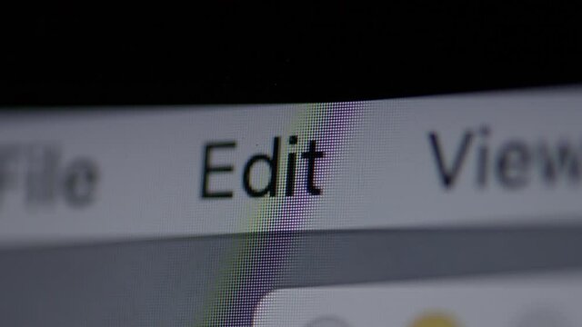 Closeup on Edit menu item on a computer screen with a slow push forward.