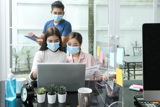 Group Of Asian Business People Meeting And Working At Home And Wear Mask For Protect Prevent Infection Covid 19.concecp Social Distance For New Generation Business