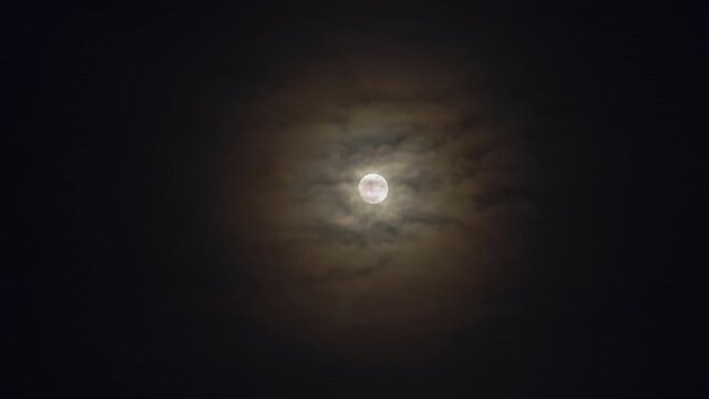 Footage b roll of Timelapse of clouds moving in night sky. Thick clouds cover moon. Time lapse The Moon in night.